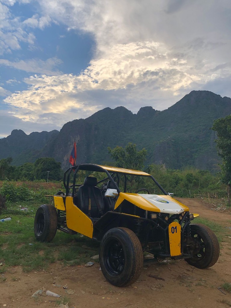 Yellow buggy number 01 with limestone mountains