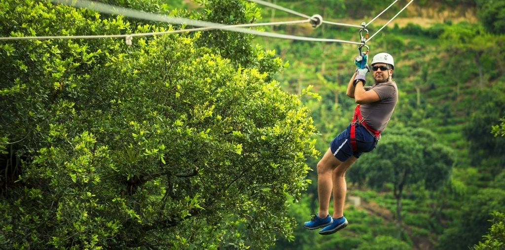 Zipline adventure over green hills in Vang Vieng